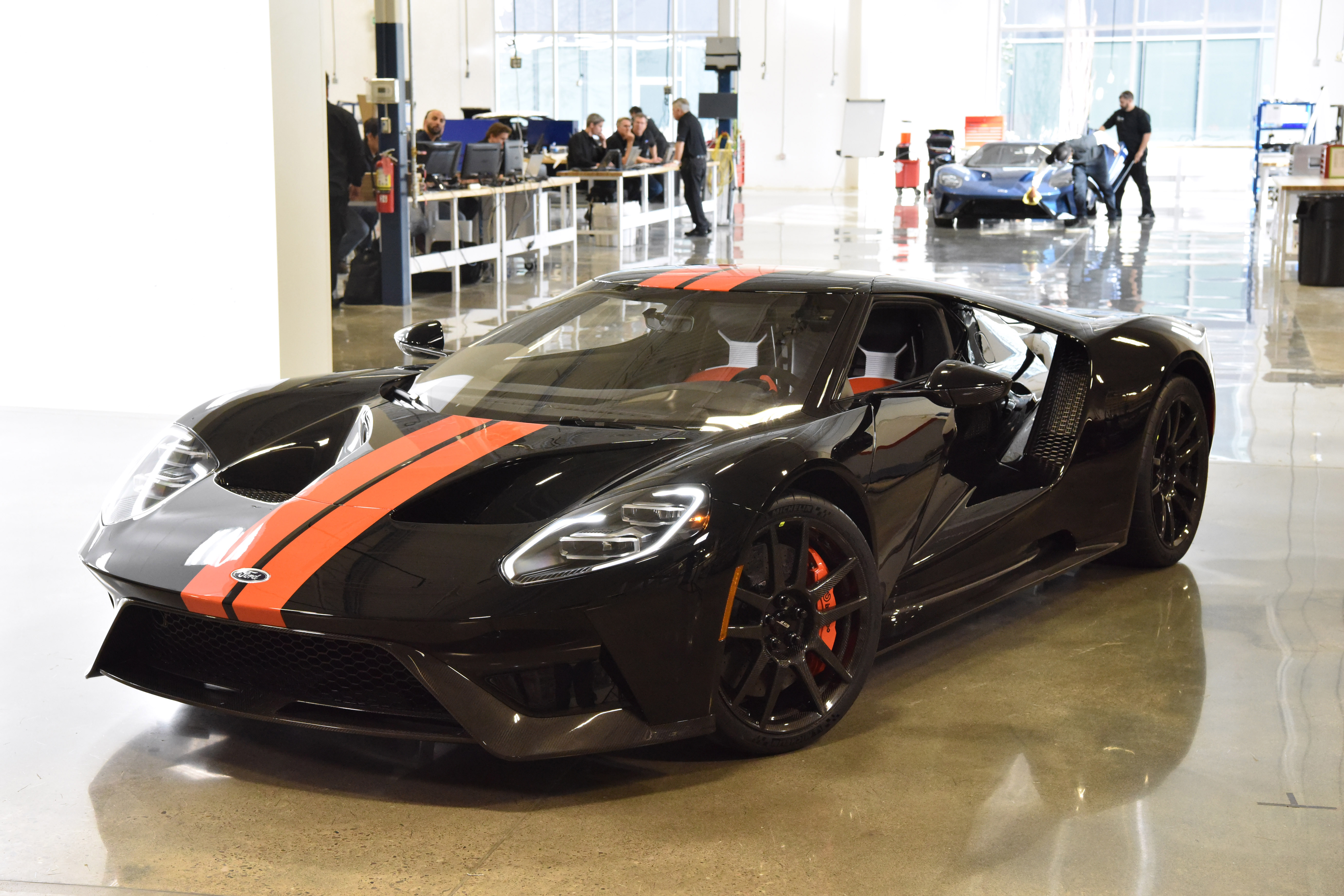 MARKHAM, Ontario, Canada, Dec. 16, 2016--Raj Nair, Ford executive VP, global product development and chief technical officer, drove the Ford GT supercar off the line to help celebrate the event along with employees and guests. The all-new Ford GT is entering the final phase of development and production has begun. One of the first Ford GTs is being driven off the line at the Multimatic assembly location with the first behind the scenes look at the assembly line for all-new Ford GT. The Ford GT is the culmination of years of Ford innovation in aerodynamics, lightweight carbon fiber construction and ultra-efficient EcoBoost engines. Photo by: Sam VarnHagen