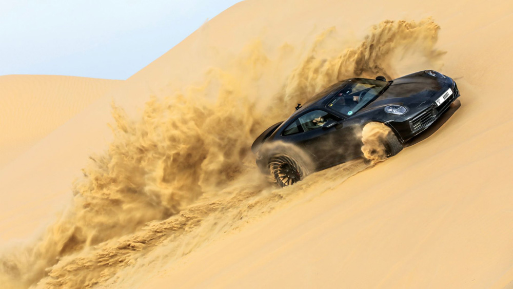 Porshce 911 Dakar edition driving in sand dunes in dubai