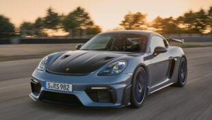 A Porsche 718 Cayman GT4 RS drives down a track straight.