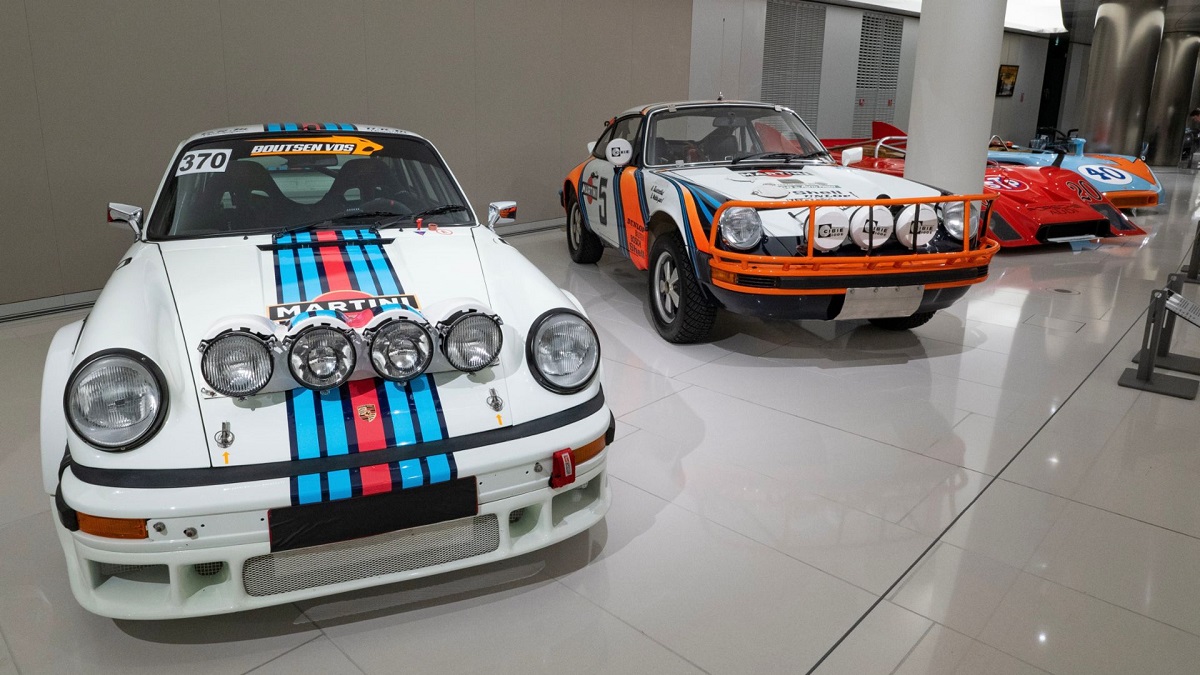 A lineup of iconic Porsche car models show off their motorsports liveries.