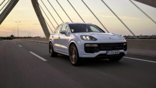 A white 2024 Porsche Cayenne E-Hybrid shows off its front-end styling.