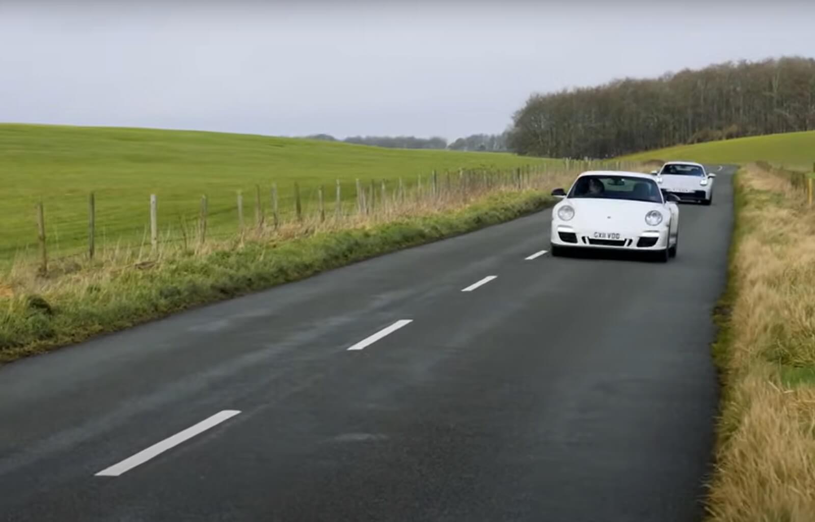 Two different Porsche 911 Carrera GTS models on the same British B road.