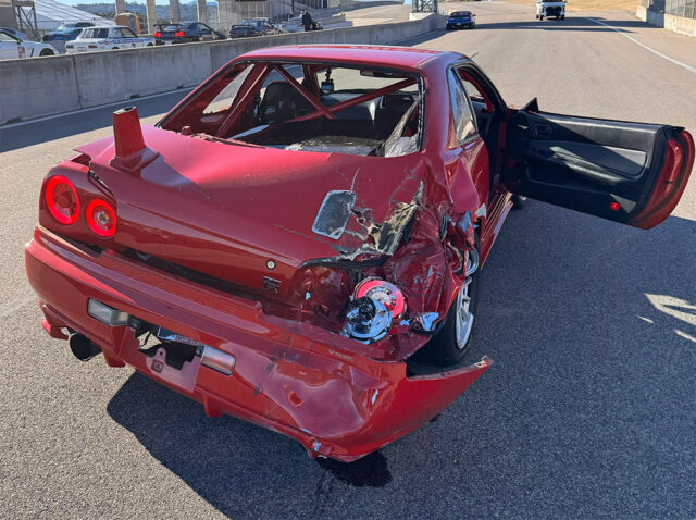 R34 Nissan Skyline GT-R totaled by telehander at WeatherTech Laguna Seca Rear
