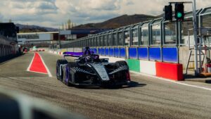 The new Porsche 975 RSE Formula E race car exiting the pit lane.