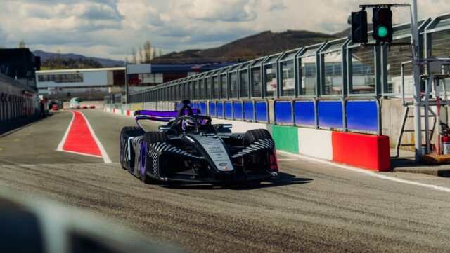 The new Porsche 975 RSE Formula E race car exiting the pit lane.